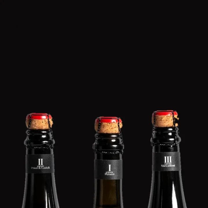 Necks of Anticelebration Cuvée II, I and III with their corks and cages