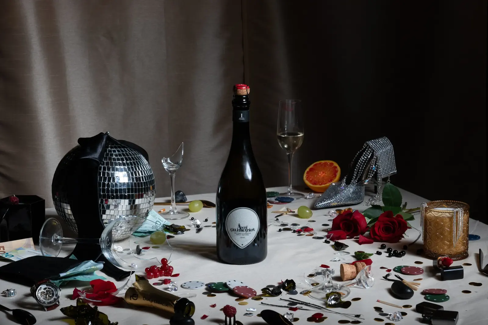 Anticelebration: an after-party table with the bottle among glitter, roses and a disco ball